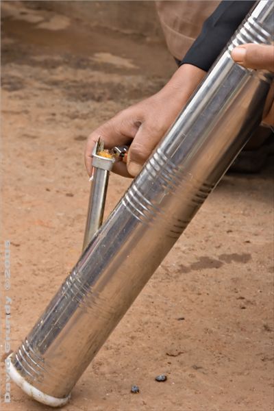 GuiShan market day - water pipe technique.  Each twist of tobacco was indivudally stuffed into the pipe and then lit.