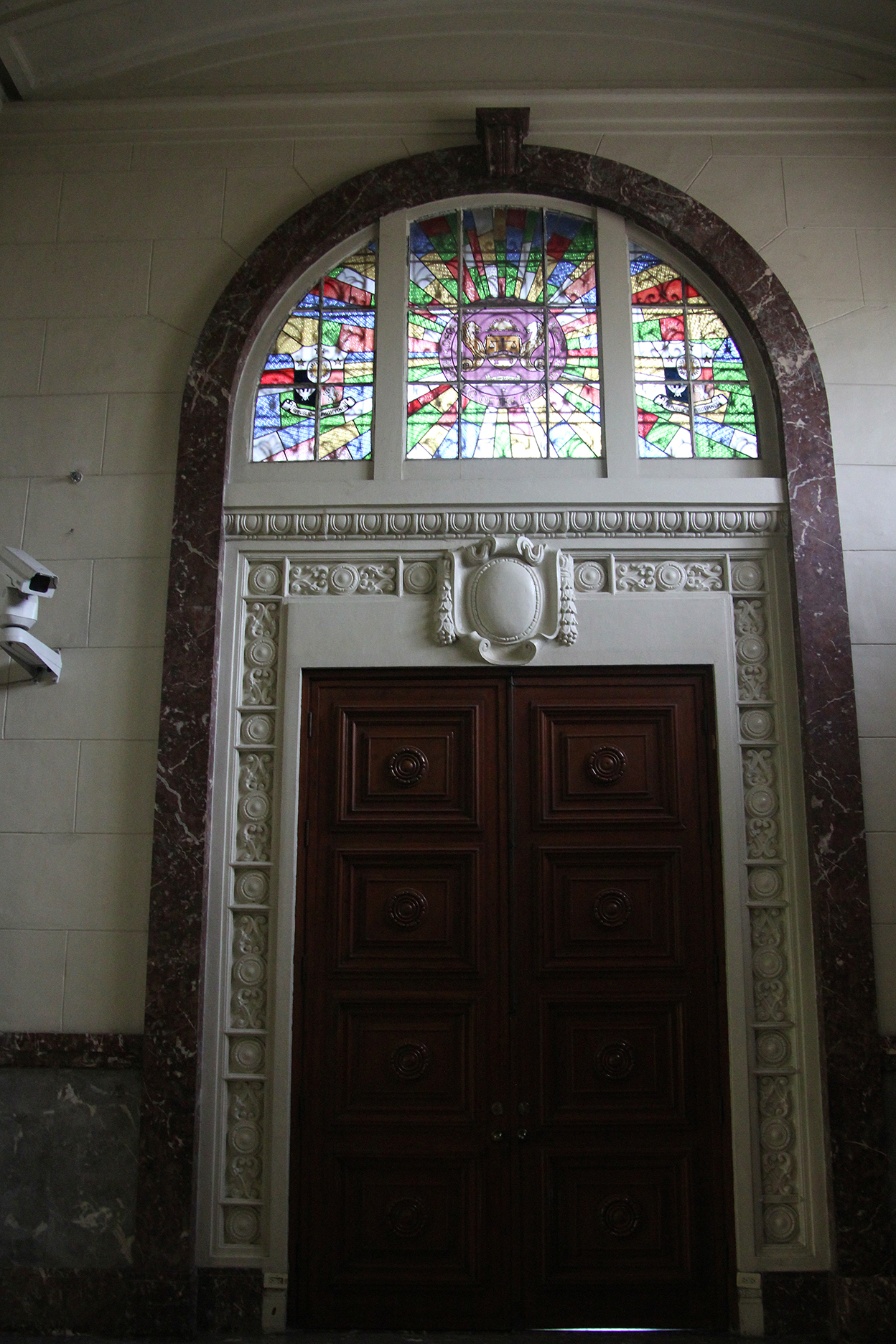 Stained glass window over the door of Marble Hall.