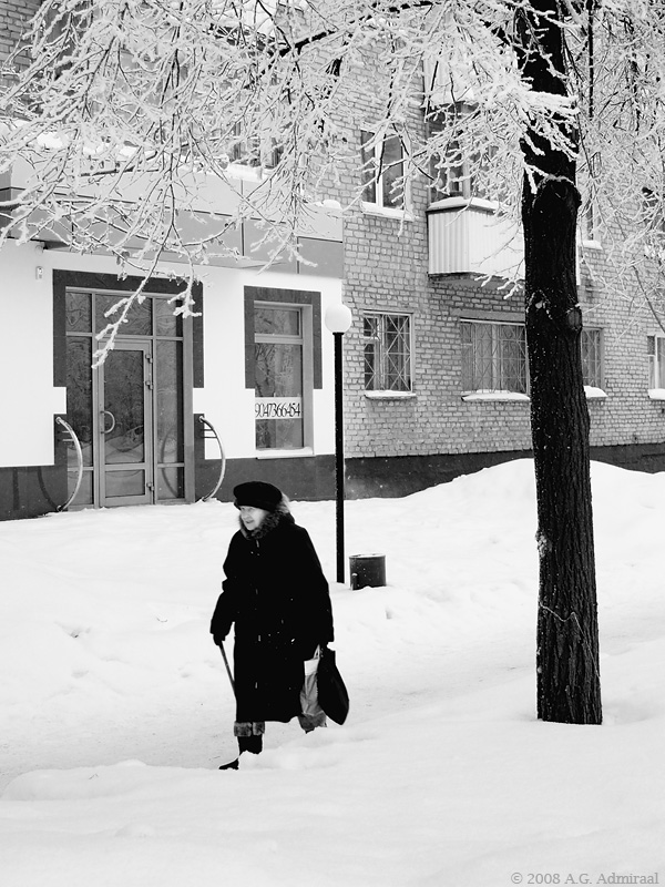 Old woman on snow covered street