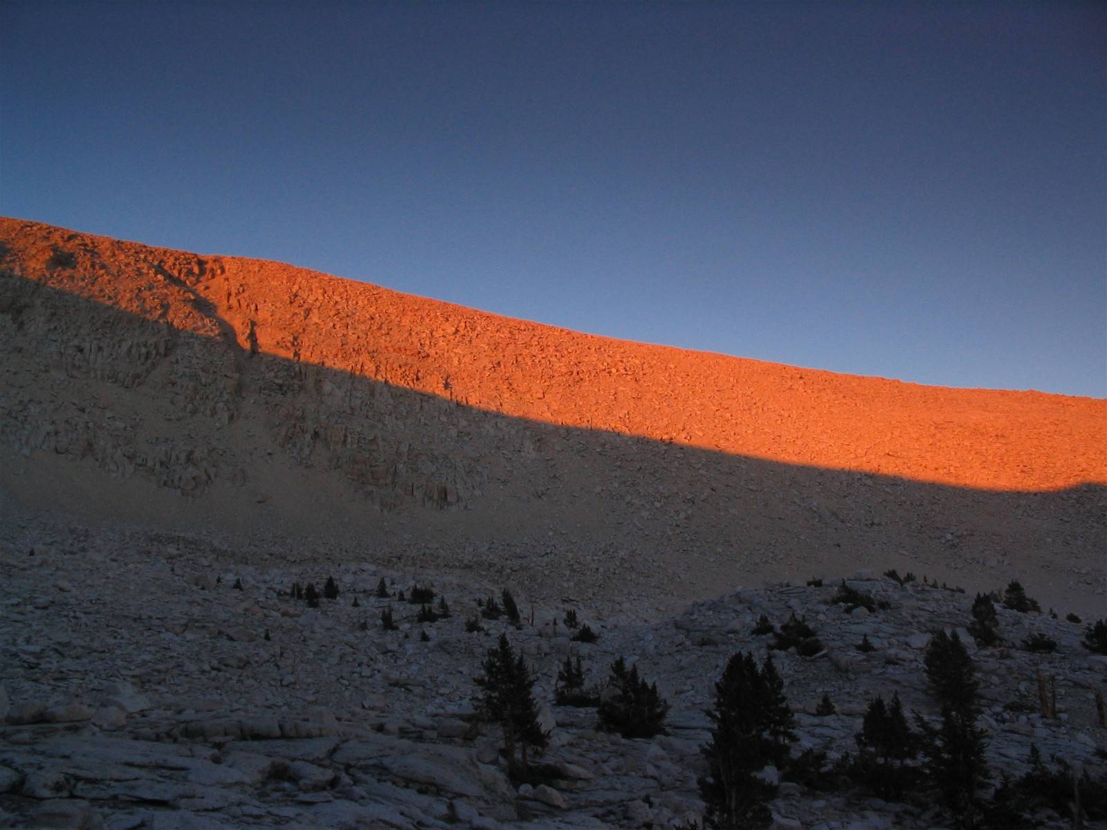 Sunset color bands on ridges above lake near southern edge of Sequoia National Park