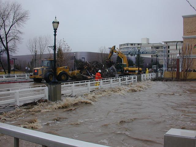 workers scooped debris to abate damn effect