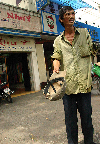 Yet another landmine Victim, HCMC.  Probably a war criminal as hes lost an arm. They were made to clear the fields of mines.