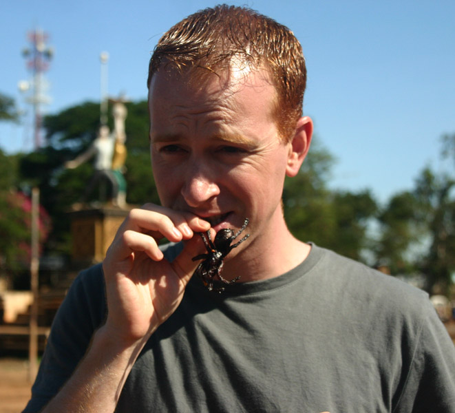 Hmmn, tastes like chicken! Eating a spider. For some reason.. Skoon, Cambodia.