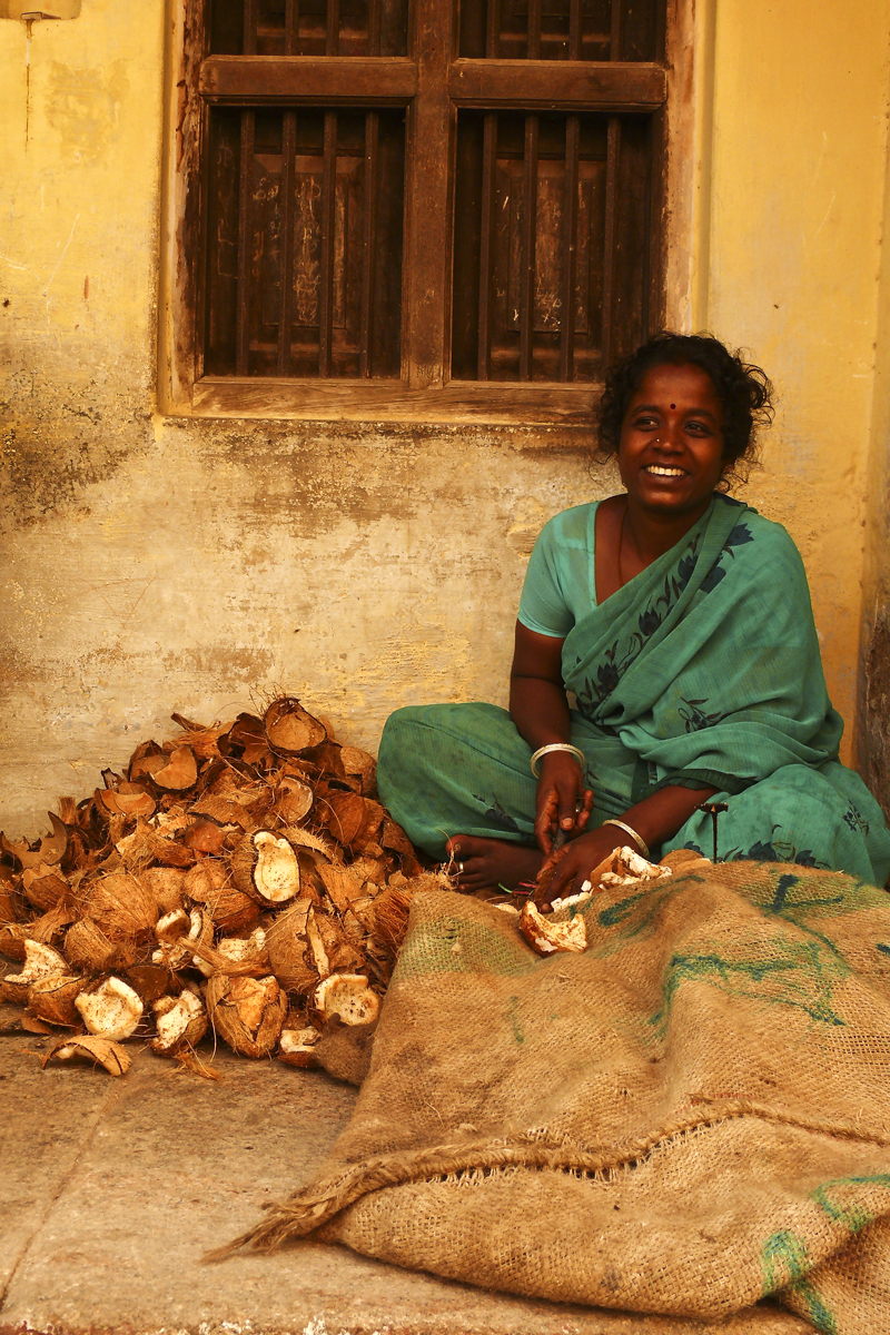 Woman with coconut peels Madurai.jpg
