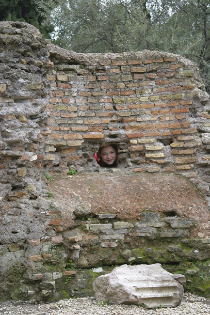 Katie peeking through a hole in the wall