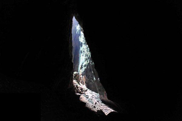 Light from a hole in the ceiling illuminating part of the Dark Cave