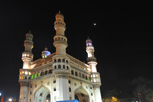 Night view of the Charminar with a crescent moon