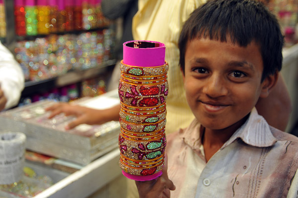 Hyderabadi boy displaying the bangle shop's wares, Laad Bazaar