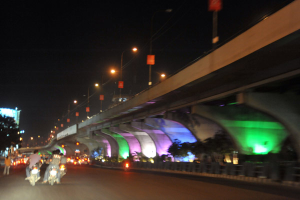 Telugu Talli Flyover illuminated in color at night