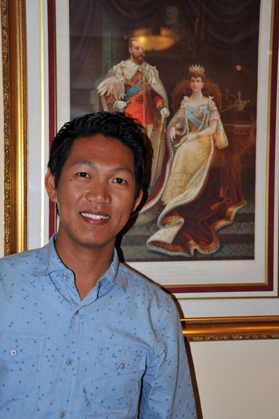 Dennis with a portrait of George V and Queen Mary at the Imperial