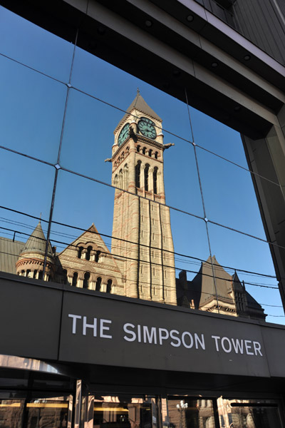 Reflection of the Old City Hall Clock Tower in the glass Simpson Tower