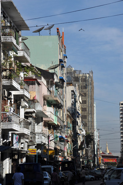 Residential street in western Yangon with the Shwedagon Pagoda visible in the distance