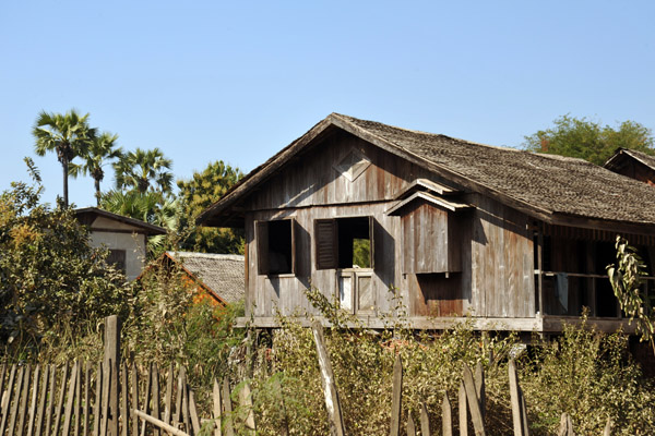 Stilt house made of wooden planks as opposed to woven palm fronds