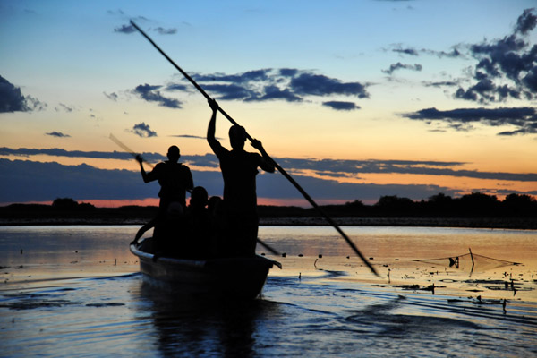 Silhouette of the polers after sunset, Bangweulu Swamps