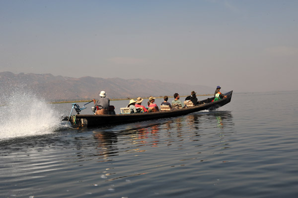 Boat load of tourists speeding across Inle Lake