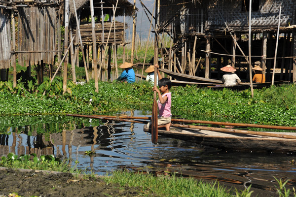 Girl on a canoe in one of the stilt villages in the middle of Inle Lake