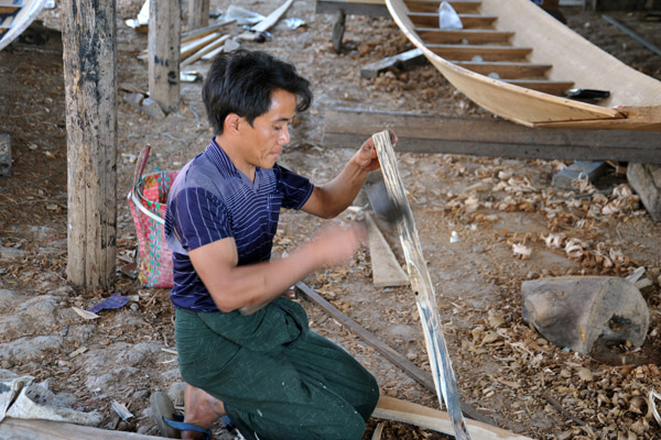 Inle Lake boat building shaping a piece of wood