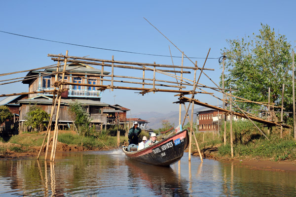 Tourist boat passing beneath a bamboo bridge, Ywama