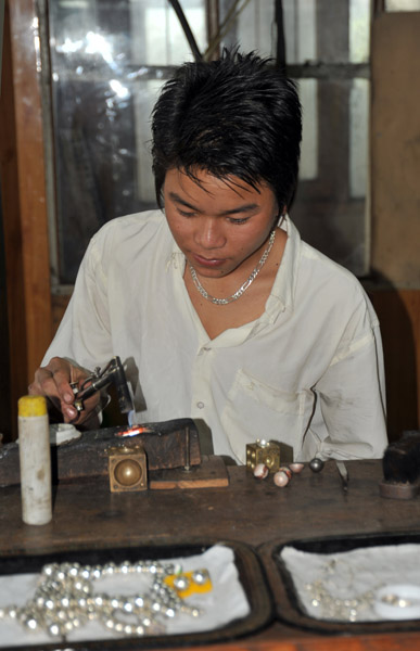Young silversmith at work, Ywama