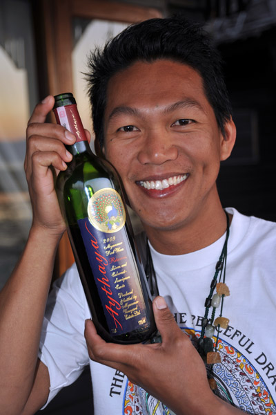 Dennis with a bottle of Myanmar red wine