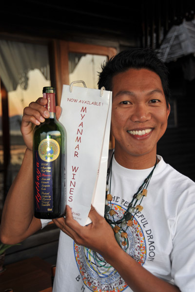 Dennis with a bottle of Myanmar red wine