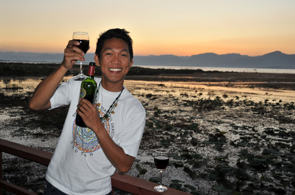 Enjoying a glass of Myanmar red wine on the terrace at Myanmar Treasure Resort, Inle Lake