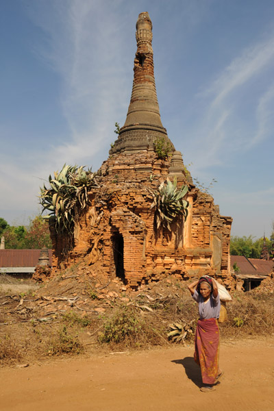 Old woman passing a ruined stupa, Nyaung Ohak