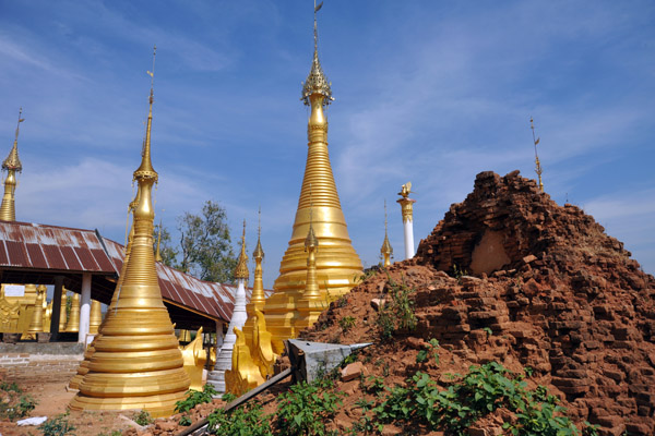 Several fully restored stupas next to a mound of one that was just too far gone for help...