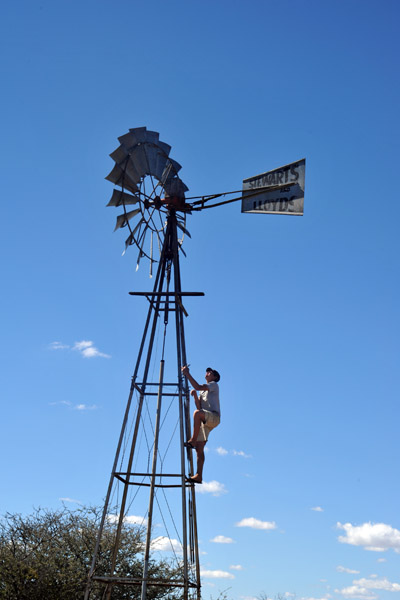Peter climbing to fix a wind mill