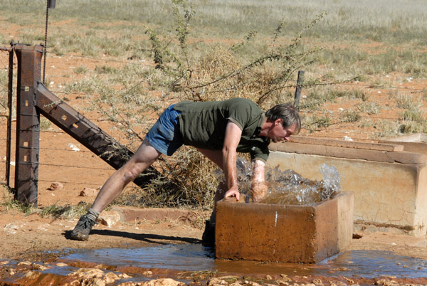 Eckhart cleaning out a water trough
