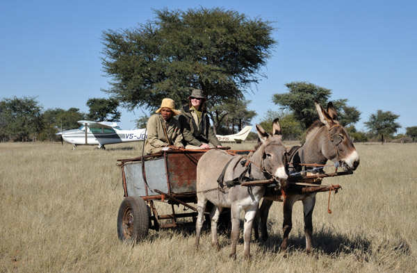 Anna getting a ride from a farm-hand in the donkey cart