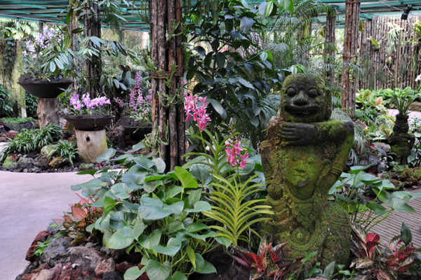 Moss covered statue in the Mist House, National Orchid Garden