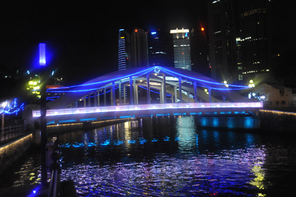 Bridge over the Singapore River illuminated in blue