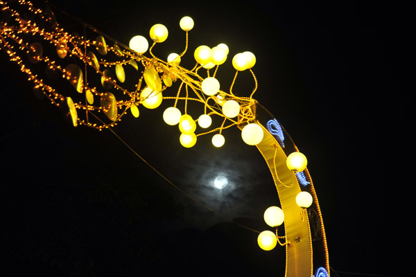 Christmas ornaments with the full moon seen through clouds, Singapore