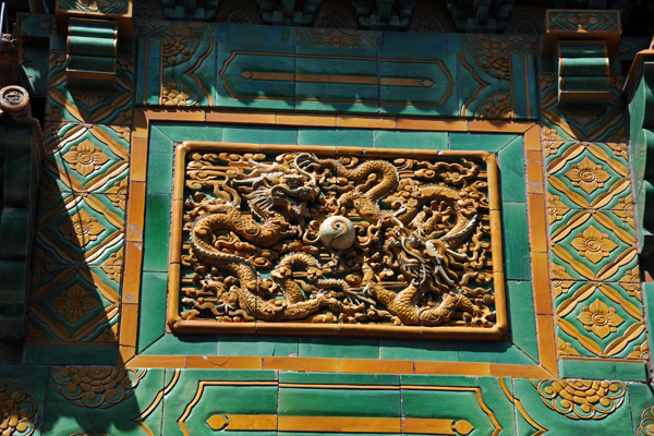 Detail of a panel with two dragons on the Glazed Memorial Arch