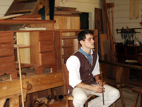 Costumed interpreter in the Cabinetmaker's shop