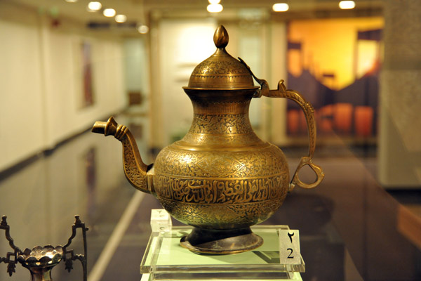 Brass ewer decorated with Arabic calligraphy and floral motifs, India