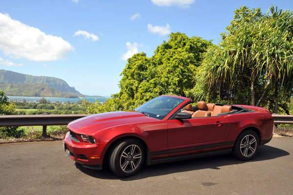 Driving the Kuhio Highway in a red Mustang convertible 