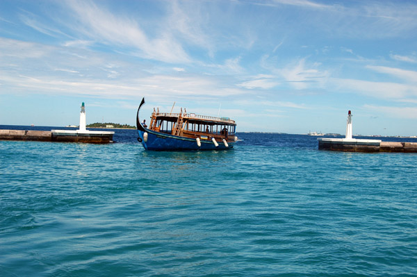 A dhoni enters the harbor on the north shore of Male'