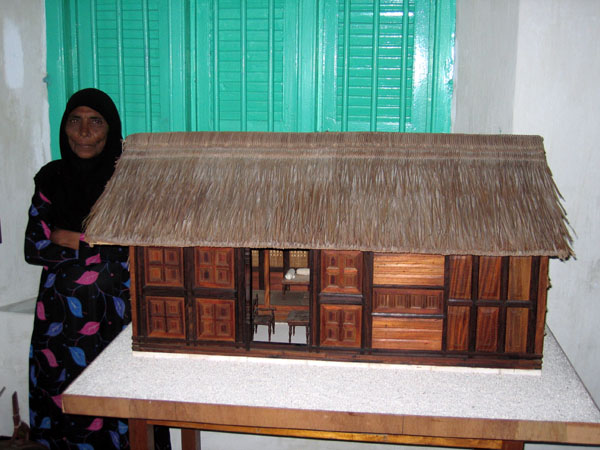 Model of a traditional house and the museum guide, National Museum of the Maldives