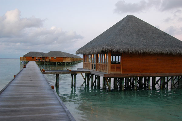 The water villas-the large building is the Meeru Village Fitness Center & Spa