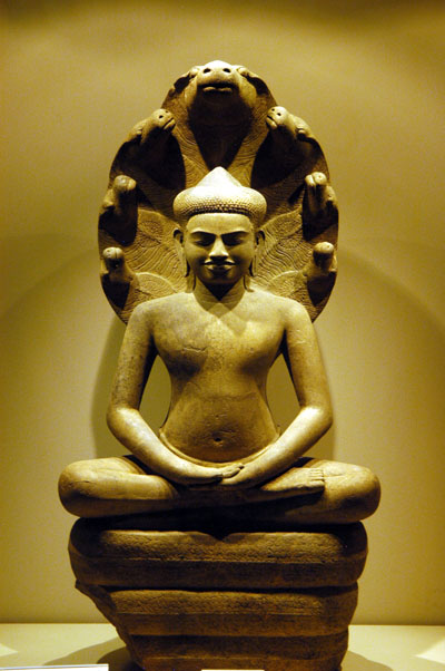 Sandstone figure of Buddha protected by Naga Muchalinda, 11-12 C Cambodia