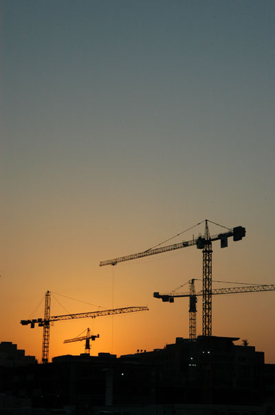 Sunset with construction cranes, Dubai