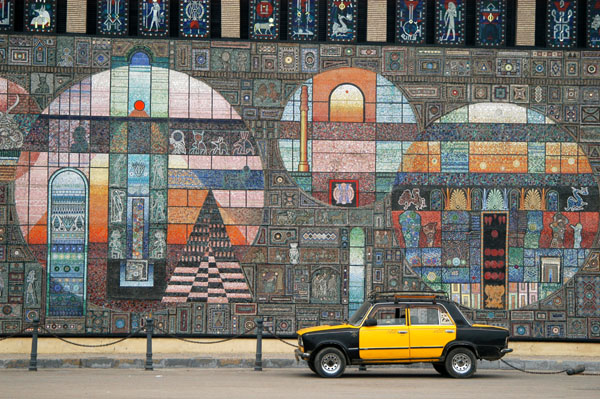 Alexandria taxi parked in front of the huge mosaic depicting the eras of Egyptian history