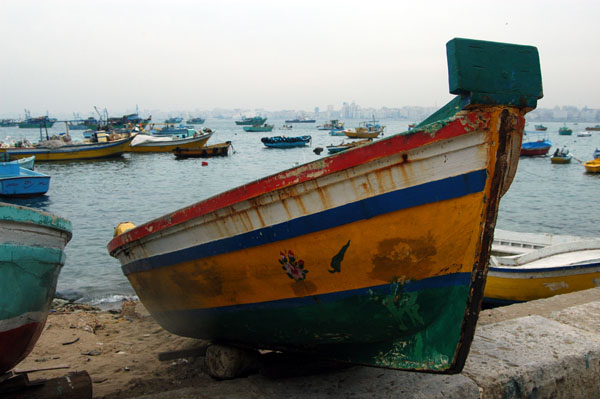 Small wooden boat pulled up alongside the Corniche, Alexandria