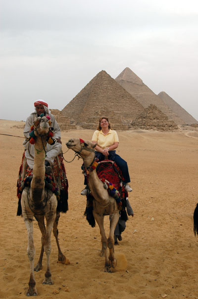 Debbie happy riding a camel at the pyramids