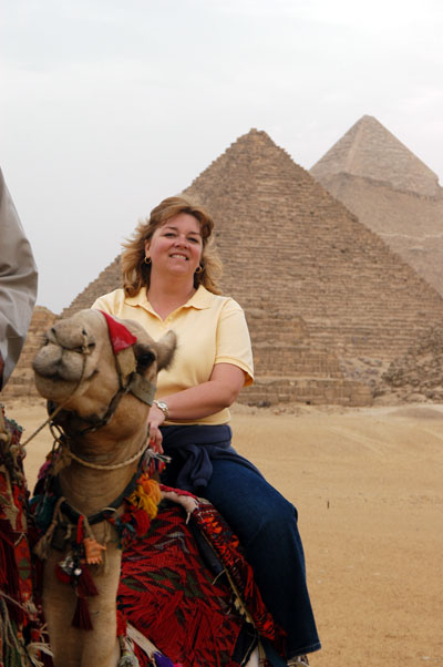 Debbie on a camel at the pyramids