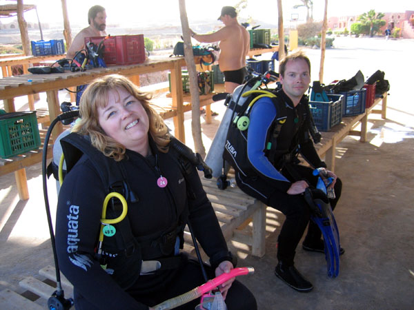 Debbie and Roy getting suited up for a dive on the Shagra Village House Reef