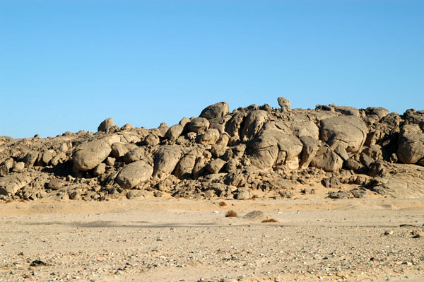 Rocky outcroppings in the desert along the highway
