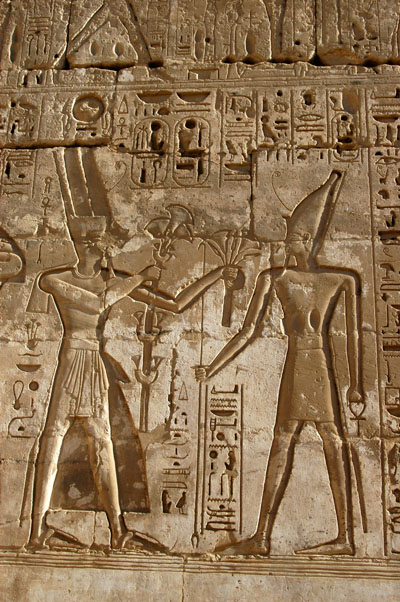 Amun offering Papyrus and Lotus symbolizing Upper and Lower Egypt